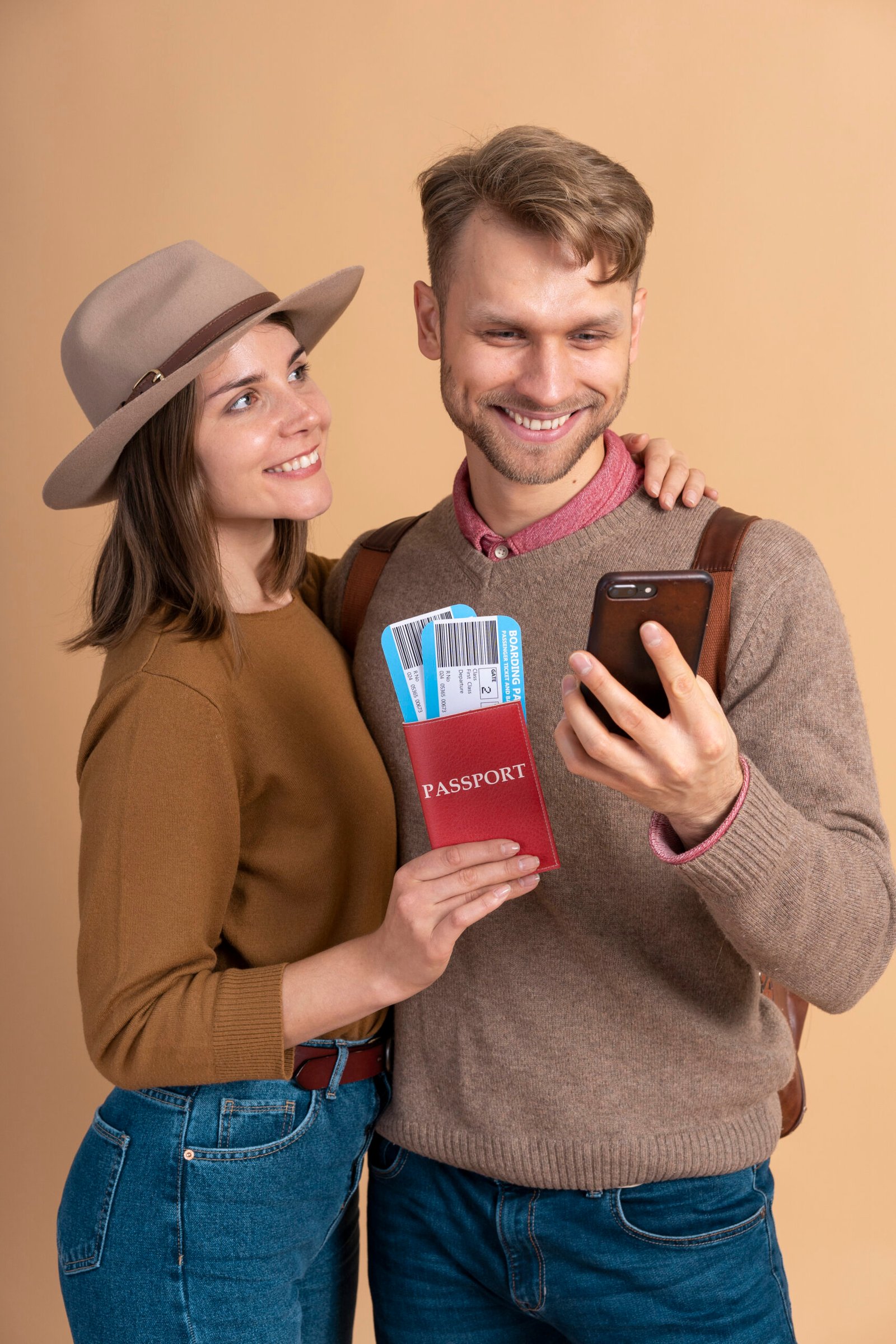 young-couple-holding-smartphone-plane-tickets-traveling